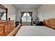 Bright bedroom with hardwood floors, a desk, and window views at 4650 Sandy Creek Dr, Cumming, GA 30028