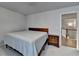 Cozy bedroom featuring carpeted floor, a bed with a wood headboard and a staircase view at 4650 Sandy Creek Dr, Cumming, GA 30028