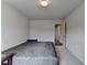 Light filled bedroom with plush carpeting, light walls, dark furniture, and view of adjacent hallway at 4650 Sandy Creek Dr, Cumming, GA 30028