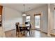 Bright dining area features a modern light fixture, wood floors, and access to the outdoor living space at 4650 Sandy Creek Dr, Cumming, GA 30028
