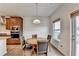 Bright breakfast nook featuring a round table and chairs adjacent to the modern kitchen area and large window at 4650 Sandy Creek Dr, Cumming, GA 30028