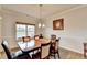 Dining room featuring hardwood floors, natural light, chandelier, and stylish decor at 4650 Sandy Creek Dr, Cumming, GA 30028