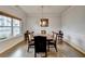 Spacious dining room with hardwood floors, large table, and sophisticated chandelier at 4650 Sandy Creek Dr, Cumming, GA 30028