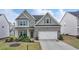 Charming two-story home boasts a brick and siding facade, well-manicured lawn, and inviting curb appeal at 4650 Sandy Creek Dr, Cumming, GA 30028