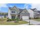 Charming two-story home boasts a brick and siding facade, well-manicured lawn, and inviting curb appeal at 4650 Sandy Creek Dr, Cumming, GA 30028