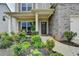 Inviting front porch showcases landscaping, a covered entrance, and stylish brick accents at 4650 Sandy Creek Dr, Cumming, GA 30028