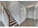 Bright entryway with hardwood floors, stairs, and neutral decor at 4650 Sandy Creek Dr, Cumming, GA 30028