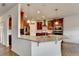Open-concept kitchen with granite countertops, stainless steel appliances, and a breakfast bar at 4650 Sandy Creek Dr, Cumming, GA 30028