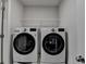 Convenient laundry room featuring modern, front-load washer and dryer at 4650 Sandy Creek Dr, Cumming, GA 30028
