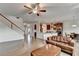 Stylish living space with open floor plan, hardwood floors, modern staircase and view of kitchen and dining area at 4650 Sandy Creek Dr, Cumming, GA 30028
