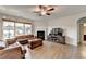 Inviting living room with hardwood floors, a cozy fireplace, and plentiful natural light from the large windows at 4650 Sandy Creek Dr, Cumming, GA 30028