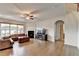 Spacious living room featuring a ceiling fan, a large window for plenty of natural light, and a fireplace at 4650 Sandy Creek Dr, Cumming, GA 30028