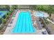 Aerial view of a community pool with plenty of lounge chairs and tables at 4650 Sandy Creek Dr, Cumming, GA 30028