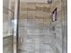 Modern shower with gray tiled walls and glass door at 4650 Sandy Creek Dr, Cumming, GA 30028