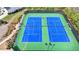 Aerial view of two community tennis courts with updated court and net systems at 4650 Sandy Creek Dr, Cumming, GA 30028