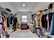 Spacious walk-in closet with hanging clothes and shelving at 4650 Sandy Creek Dr, Cumming, GA 30028