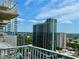 Expansive city view from balcony, showcasing neighboring buildings and greenery at 860 Peachtree Ne St # 2616, Atlanta, GA 30308