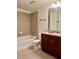 Bathroom featuring tiled shower over tub, granite countertop, and dark wood vanity at 860 Peachtree Ne St # 2616, Atlanta, GA 30308