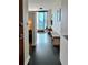 Inviting entryway with black floor, bench, and view into the well-lit living area with skyline views at 860 Peachtree Ne St # 2616, Atlanta, GA 30308