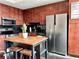 Well-equipped kitchen with stainless steel appliances, black backsplash, wood cabinets, and island with seating at 860 Peachtree Ne St # 2616, Atlanta, GA 30308