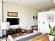Cozy living room with couch, TV, art, and rustic wood furniture accents throughout the space at 860 Peachtree Ne St # 2616, Atlanta, GA 30308