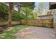 Fenced back yard with a brick patio, mature trees and terraced landscaping at 1209 Brookhaven Woods Ne Ct, Brookhaven, GA 30319