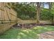 Landscaped back yard with a wooden fence, a brick patio and waterfall feature at 1209 Brookhaven Woods Ne Ct, Brookhaven, GA 30319