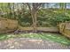 Private back yard with a wooden fence, a brick patio and waterfall feature at 1209 Brookhaven Woods Ne Ct, Brookhaven, GA 30319