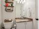 Cozy half bathroom complete with floating shelves at 1209 Brookhaven Woods Ne Ct, Brookhaven, GA 30319