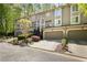 Attractive townhome exterior with a garage, landscaping, and close proximity to nature at 1209 Brookhaven Woods Ne Ct, Brookhaven, GA 30319