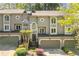 Charming townhome featuring a garage, front garden, and gray stucco exterior at 1209 Brookhaven Woods Ne Ct, Brookhaven, GA 30319