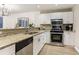 Modern kitchen featuring white cabinetry, granite countertops, and stainless steel appliances at 1209 Brookhaven Woods Ne Ct, Brookhaven, GA 30319