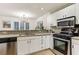 Well-lit kitchen with modern appliances, white cabinets, and granite countertops at 1209 Brookhaven Woods Ne Ct, Brookhaven, GA 30319