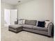 Comfortable living room featuring a large sectional couch and soft carpet at 1209 Brookhaven Woods Ne Ct, Brookhaven, GA 30319