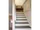 Staircase with white risers and neutral walls, leading to the upper level at 1209 Brookhaven Woods Ne Ct, Brookhaven, GA 30319