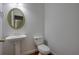 The bathroom features a pedestal sink, toilet, and a decorative gold mirror at 12554 Huntington Trce, Alpharetta, GA 30005