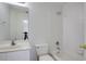 Bathroom featuring a vanity, toilet, tub, and shower with white tiling at 12554 Huntington Trce, Alpharetta, GA 30005