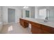 Bathroom featuring double sinks, modern fixtures, and access to a walk-in closet at 12554 Huntington Trce, Alpharetta, GA 30005