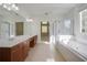 Bright bathroom featuring a double vanity, soaking tub, and separate shower at 12554 Huntington Trce, Alpharetta, GA 30005