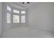 Bright bedroom with large windows and neutral carpet at 12554 Huntington Trce, Alpharetta, GA 30005