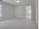 Bright bedroom with neutral carpet, ample space, and a unique round window at 12554 Huntington Trce, Alpharetta, GA 30005