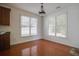 Dining area with hardwood floors and natural light coming through the large windows at 12554 Huntington Trce, Alpharetta, GA 30005