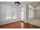 Dining area with large windows, hardwood flooring, and a door to the outside at 12554 Huntington Trce, Alpharetta, GA 30005