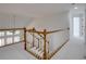Open hallway with wooden railing and white trim, leading to multiple rooms at 12554 Huntington Trce, Alpharetta, GA 30005