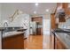 Bright kitchen with stainless steel appliances and a view of the staircase at 12554 Huntington Trce, Alpharetta, GA 30005