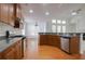 Spacious kitchen with wood cabinets, stainless steel appliances and a large island with a sink at 12554 Huntington Trce, Alpharetta, GA 30005