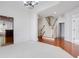 Spacious living room with white carpet, staircase, and elegant chandelier at 12554 Huntington Trce, Alpharetta, GA 30005