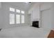 Bright living room with a fireplace and large windows providing natural light at 12554 Huntington Trce, Alpharetta, GA 30005