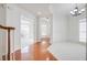 Open-concept living room featuring hardwood floors, staircase, and wainscoting at 12554 Huntington Trce, Alpharetta, GA 30005