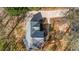 Aerial shot showcases the home's roof, driveway, and lush landscaping with surrounding trees and shrubs at 3139 Players Dr, Jonesboro, GA 30236